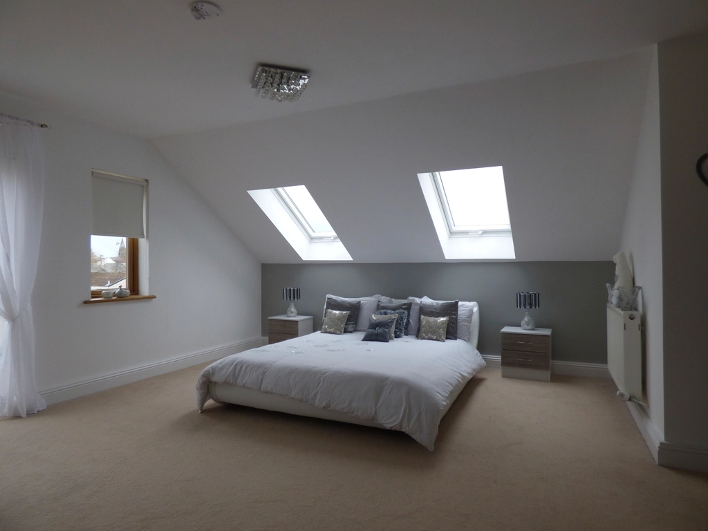 Bright bedroom with a freshly made bed